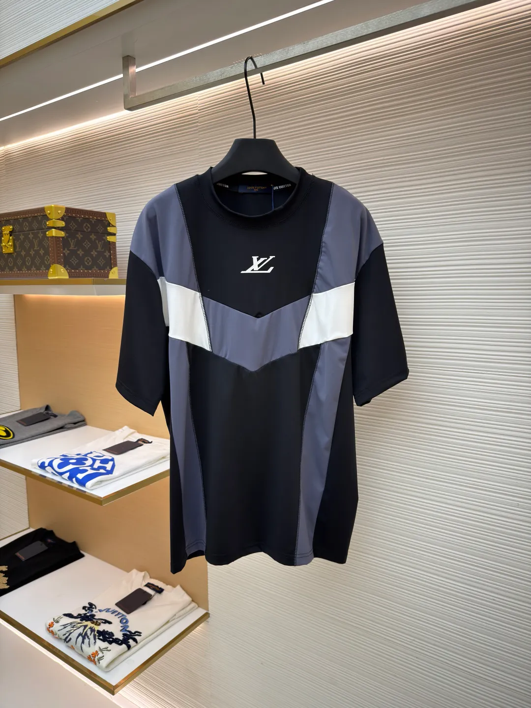 LOUIS VUITTON Spliced round neck jogging short-sleeved T-shirt ●Original version: purchased and developed by 8167 ●Item number: 1682020-A20 ●Fabric: cotton fabric ●Technology: made on positioning cutting machine ●Color: black, gray and white ●Type: fitted version ●Weight: about 295 grams ●Size: S-M-L-XL ●Description: This LOUIS VUITTON The FW25 jogging short-sleeved T-shirt is made of high-elastic technical knitted fabric (presumably a blend of polyester fiber and spandex). It has been treated with directional stretching technology and has both breathability and sports extensibility. The body of the garment adopts color-blocking insert technology: black, gray, and white panels are spliced ​​diagonally in a V-shape, and the edges are processed with "boneless overlocking" to make the seams smooth and smooth. The "LV" logo on the chest uses a silicone embossing + embroidery composite process: first outline the outline with embroidery thread of the same color, and then cover it with a matte silicone layer, which not only ensures the three-dimensionality of the logo, but also prevents it from falling off after washing. The neckline is double-layered ribbed and has built-in elastic webbing for reinforcement, making it less likely to deform after long-term wear. The overall shape is sporty and slim-fitting, and the arc of the cut piece has been ergonomically optimized, making it suitable for light sports such as jogging. The overall wiring is straight and delicate, the fabric is comfortable and soft, and the color is consistent without color difference. It can be matched with the same style to create a fashionable look and control various occasions. Customized accessories, complete with three standards, same style for men and women!